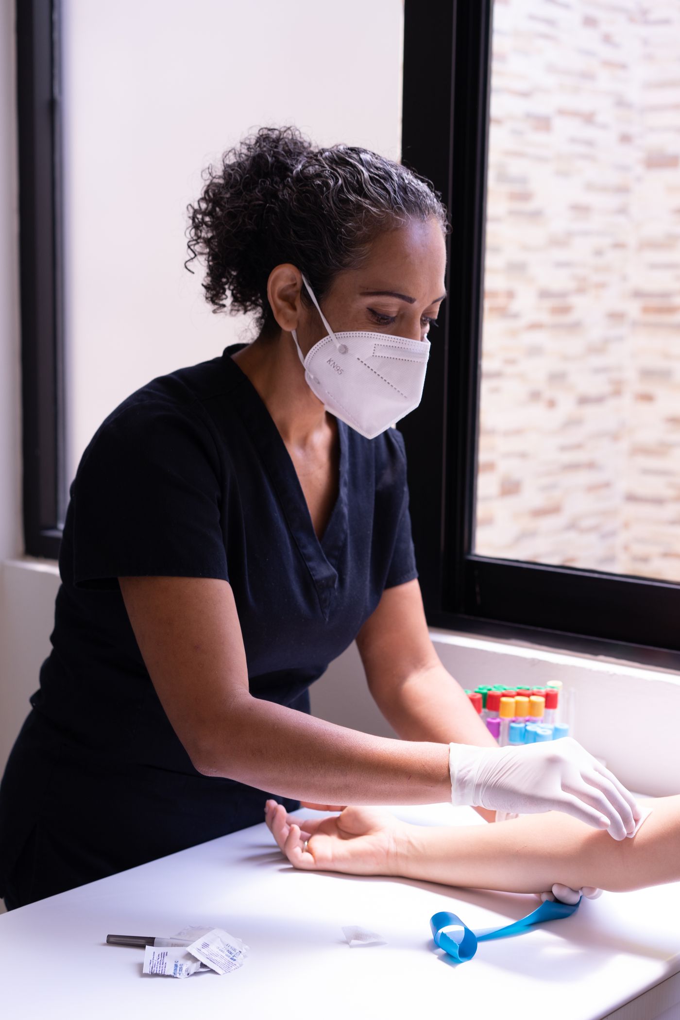 Healthcare worker preparing a patient for a blood test